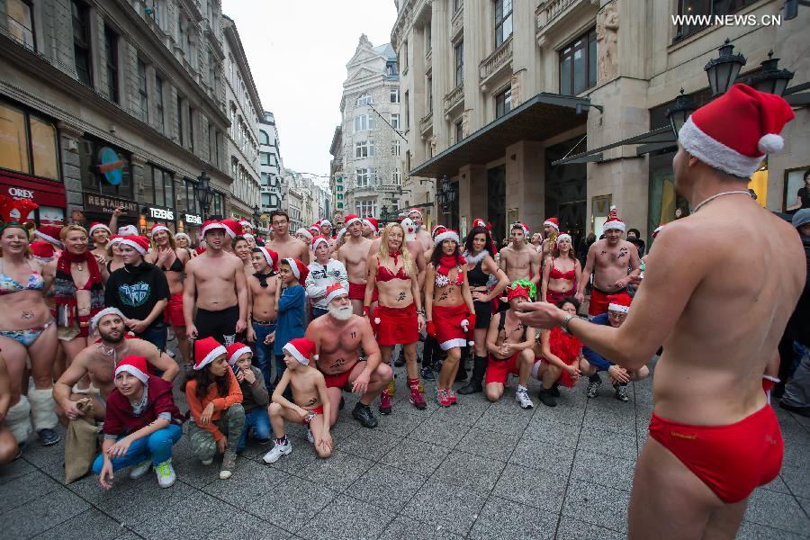 Half naked runners pose for photos ahead of the 11th 'Santa Speedo Run' for charity in Budapest, Hungary on Dec. 7, 2014. The event aims to raise money for Budapest's Burattino School Foundation which runs a school for children from poor families. [Photo/Xinhua] 