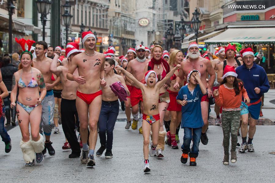 Half naked runners attend the 11th 'Santa Speedo Run' for charity in Budapest, Hungary on Dec. 7, 2014. The event aims to raise money for Budapest's Burattino School Foundation which runs a school for children from poor families. [Photo/Xinhua] 