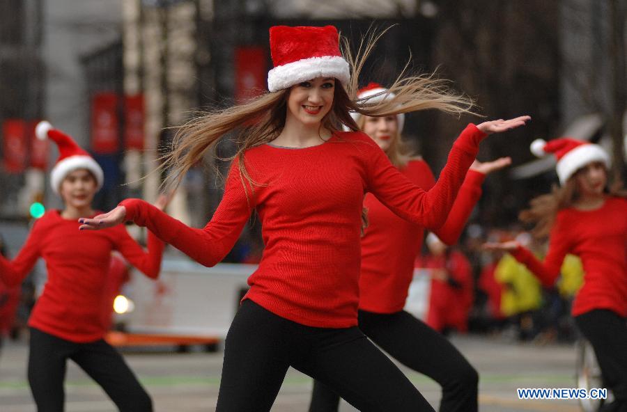 Dancers perform during the Santa Claus Parade in Vancouver, Canada, Dec. 7, 2014. The 11th annual parade attracted more than 300,000 spectators and featured 3,800 participants and 300 volunteers as a pre-Christmas tour through the streets of Vancouver. [Photo/Xinhua]
