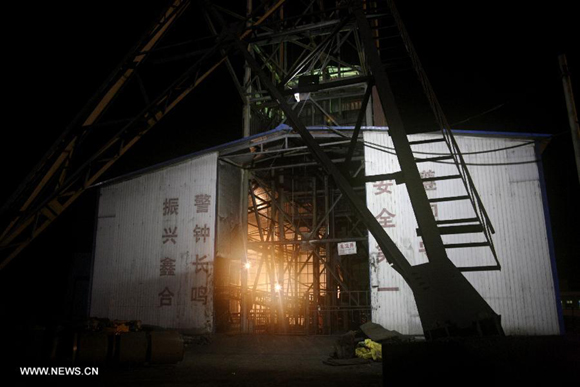 Photo taken on Dec. 12, 2014 shows the shaft of a colliery run by Xinhe Coal Mining Company in Chengcheng County, northwest China's Shaanxi Province. Four people were trapped underground in wake of a coal mine fire here Friday, local authorities said.