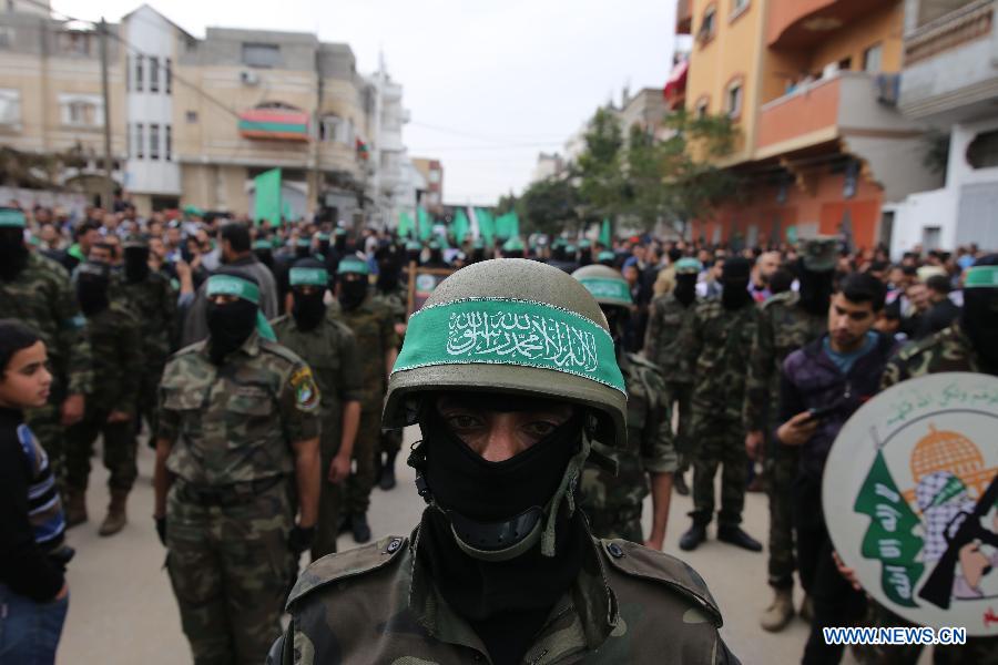 A Palestinian militant wears the headband of Hamas armed wing during a rally ahead of the 27th founding anniversary of Hamas, in the southern Gaza Strip city of Rafah, on Dec. 12, 2014