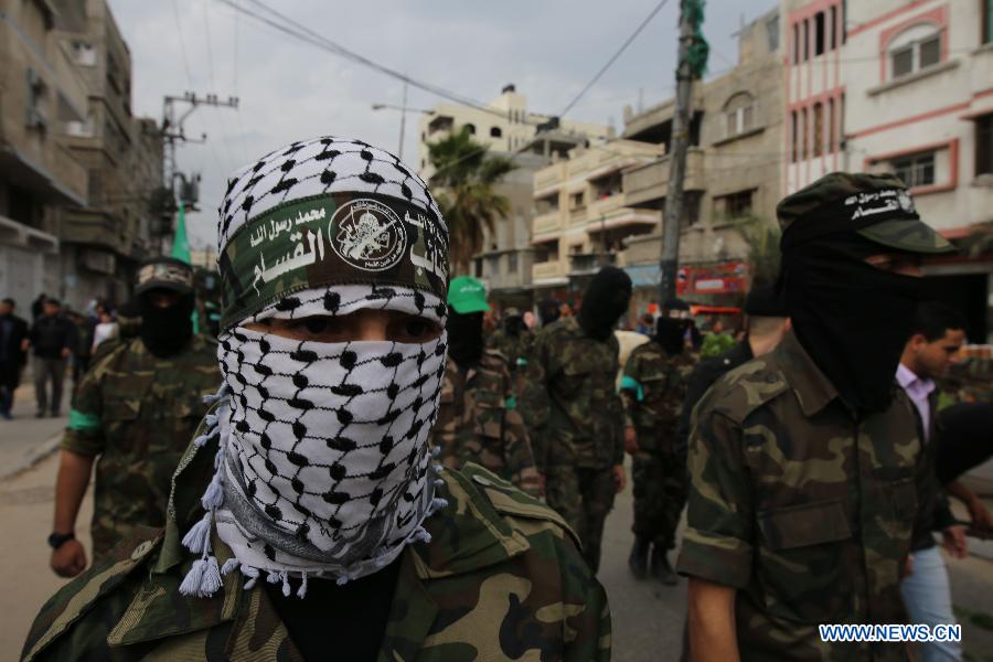 Palestinian militants attend a rally ahead of the 27th founding anniversary of Hamas, in the southern Gaza Strip city of Rafah, on December 12, 2014. 