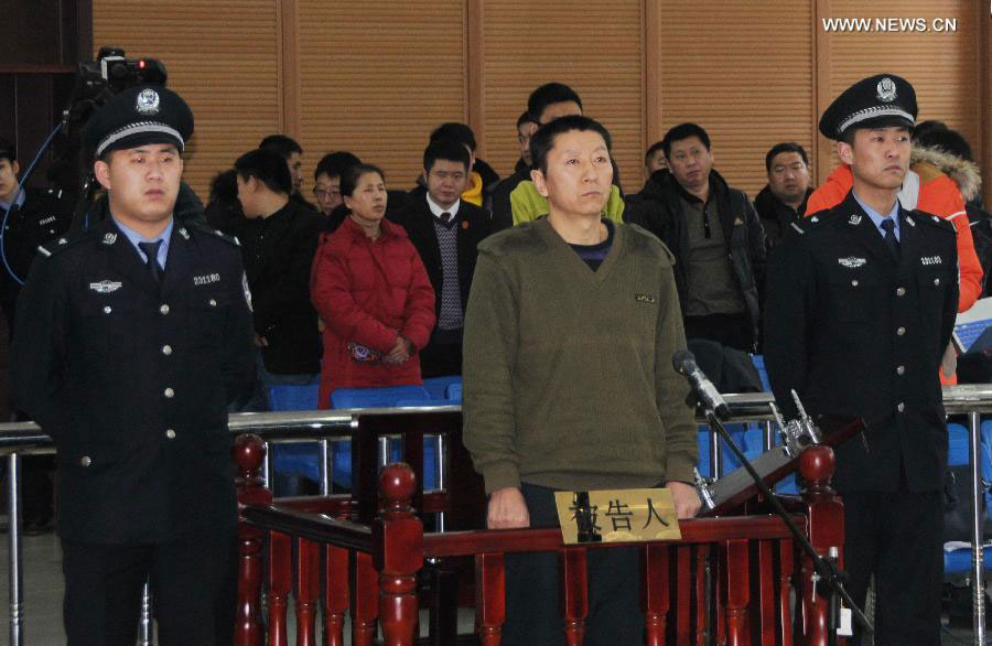 Qi Quanjun, former captain of the flight VD8387, stands trial at the People's Court of Yichun District of Yichun City, northeast China's Heilongjiang Province, Dec. 19, 2014.