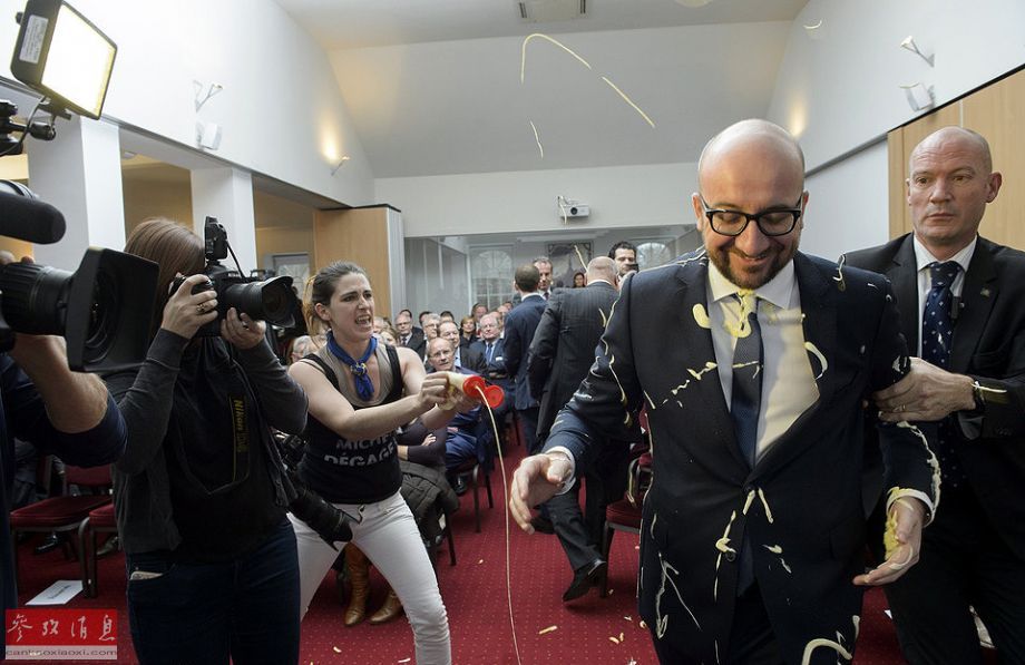 Feminists throw fries, mayo at the Belgian prime minister, Charles Michel, at a conference in Namur on Monday. [Photo/cankaoxiaoxi] 