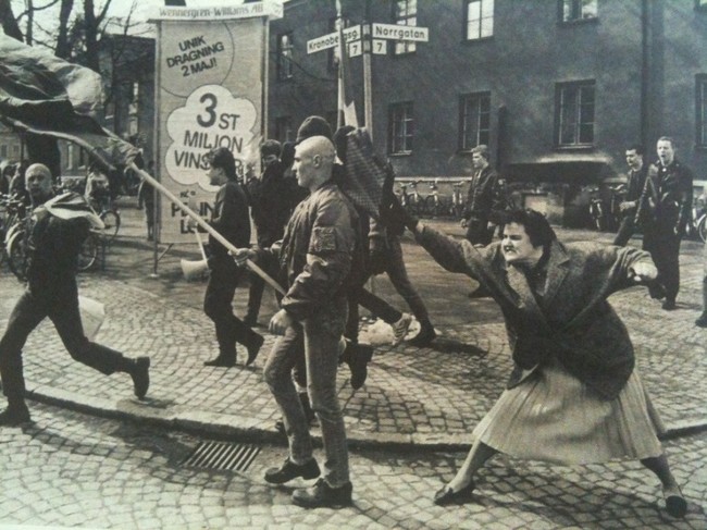 A Swedish woman hitting a neo-Nazi protester with her handbag. The woman was reportedly a concentration camp survivor. [1985] [Web photo]