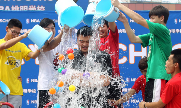 Former NBA star Yao Ming takes an ice bucket challenge in Beijing. [Photo/China Daily]