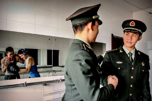 Two soldiers in uniform vs the same men boxing out of uniform in the same photo. [Photo/PLA Daily] 