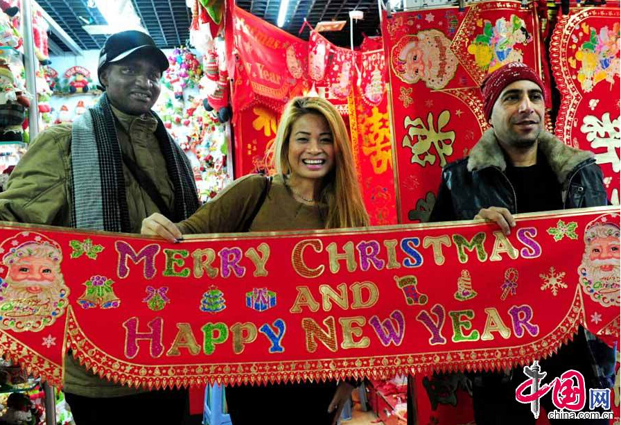 Foreign clients from Venezuela, Uganda and India came to a market in Yiwu, Zhejiang Province to buy Christmas gifts on Dec. 22, 2014. There are more than 5,200 enterprises and stores in Yiwu City that are allowed to sell goods to foreign businesses. More than 130,000 foreign merchants from over 80 countries purchase and trade here. [China.org.cn] 