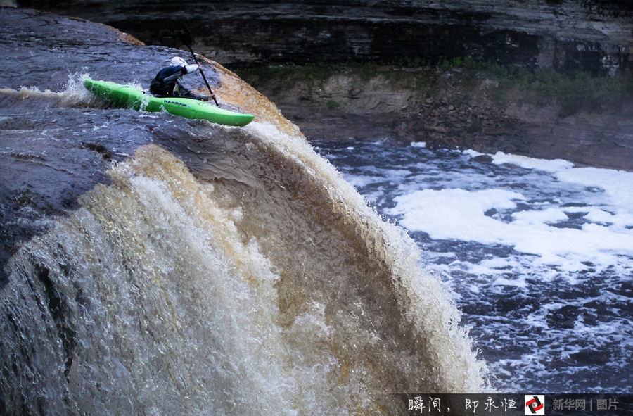 A 27-year-old Brazil kayakers rows a kayak down a rushing waterfall of 50 feet high. [Photo/Xinhuanet]