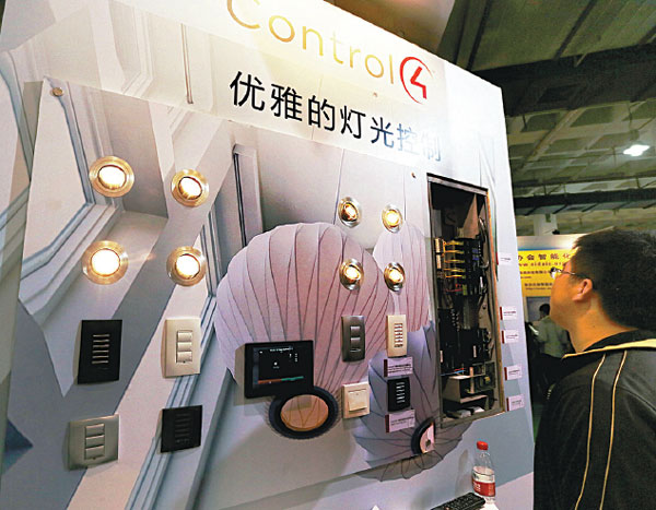 Visitors examine smart lighting system on display at an exhibition in Beijing. The smart home concept has taken on a rising number of urban residents in China. Provided to China Daily 