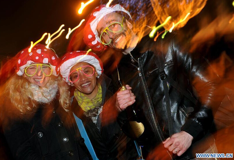 People celebrate the New Year's Eve on the Champs Elysees avenue in Paris, France, Dec. 31, 2014. (Xinhua/Chen Xiaowei)