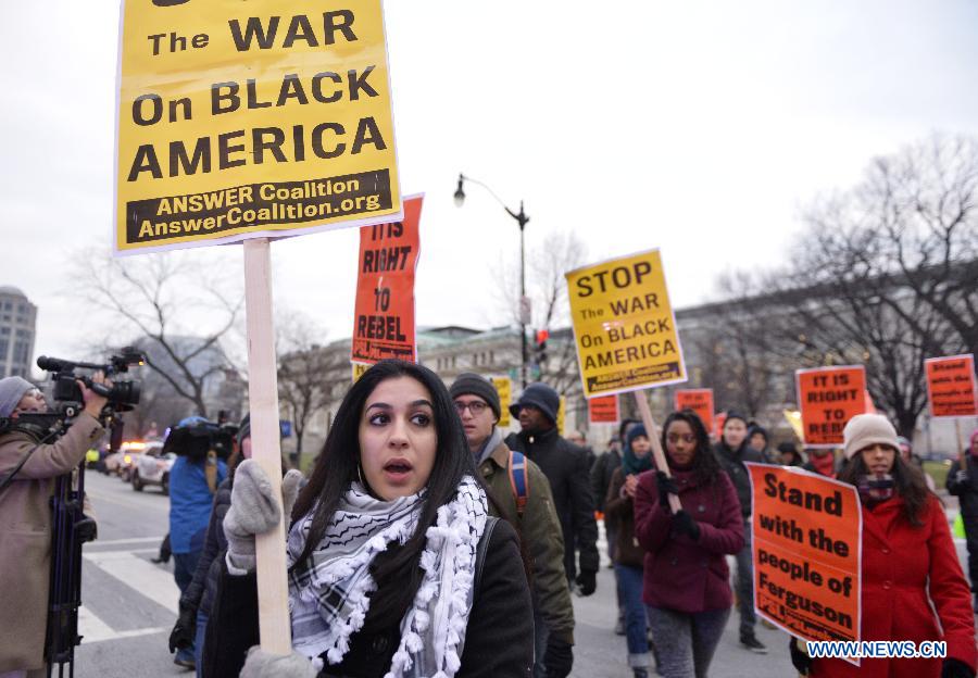 People attend a demonstration to shut down the traffic protesting against racism and injustice to mark the birthday of Martin Luther King Jr. in Washington D.C., the United States, Jan. 15, 2015. [Photo/Xinhua] 