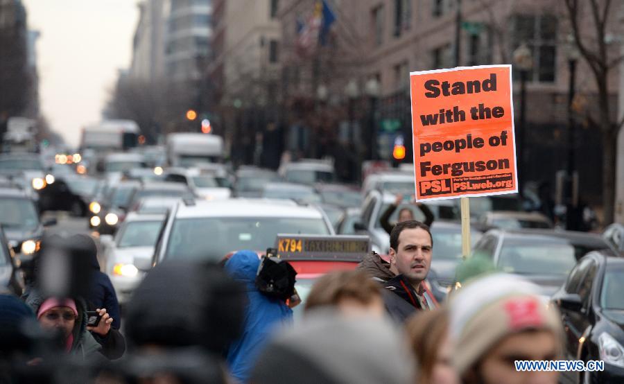 People attend a demonstration to shut down the traffic protesting against racism and injustice to mark the birthday of Martin Luther King Jr. in Washington D.C., the United States, Jan. 15, 2015. [Photo/Xinhua]