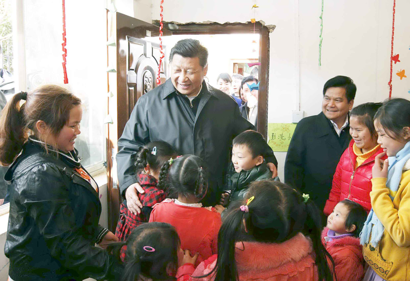 Chinese President Xi Jinping meets with the children staying at a temporary camp set up in Ganjiazhai Village for those displaced by the 6.5 magnitude earthquake in August last year, in Ludian County, southwest China's Yunnan Province on Jan 19, 2015. [Photo: Xinhua] 