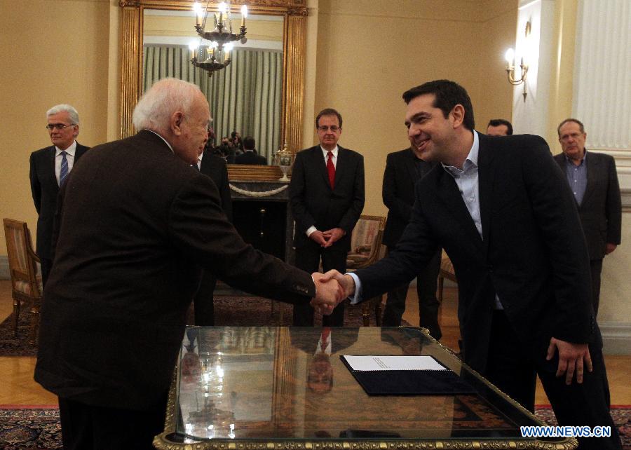 SYRIZA party leader Alexis Tsipras (R), shakes hands with President of Greek President Karolos Papoulias at the Presidential Palace in Athens, Greece, Jan. 26, 2015. Tsipras was sworn in on Monday as Greece's new Prime Minister to head a coalition government after winning Sunday's national elections. [Photo/Xinhua]