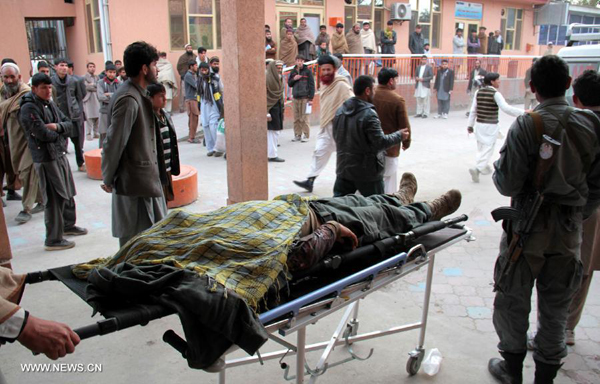 Afghans carry the body of a suicide bombing victim in Afghanistan's eastern province of Nangarhar on Jan. 29, 2015. More than 40 people have been killed and more than 50 others wounded in attacks and clashes in Afghanistan since late Wednesday. 