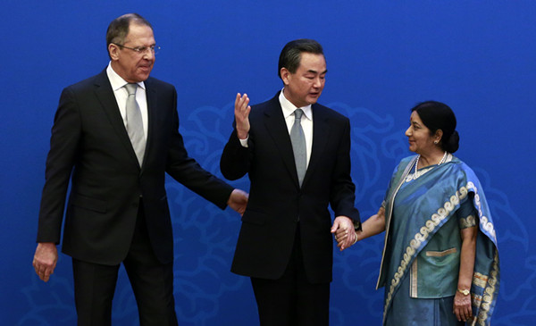 Foreign Minister Wang Yi (center) meets with his Indian counterpart Sushma Swaraj (right) and Russian Foreign Minister Sergei Lavrov in Beijing on Monday for a regular trilateral meeting among the foreign ministers of the three countries.