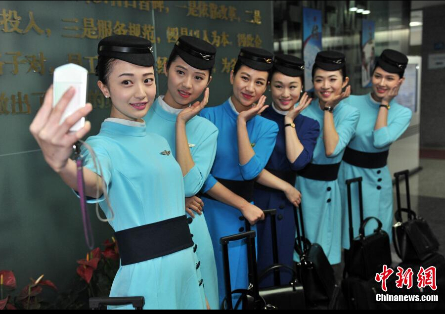 Airline stewardesses of Xiamen Air show their new uniforms on Feb. 6, 2015.