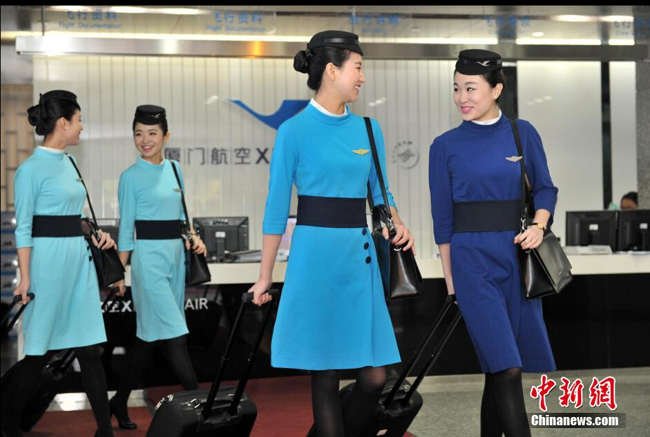 Airline stewardesses of Xiamen Air show their new uniforms on Feb. 6, 2015.