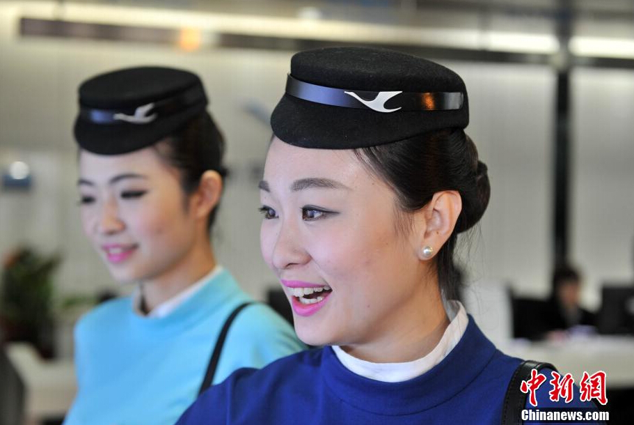 Airline stewardesses of Xiamen Air show their new uniforms on Feb. 6, 2015.