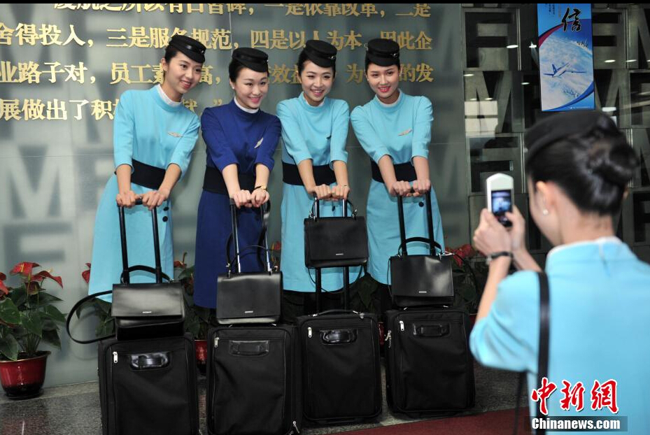 Airline stewardesses of Xiamen Air show their new uniforms on Feb. 6, 2015.