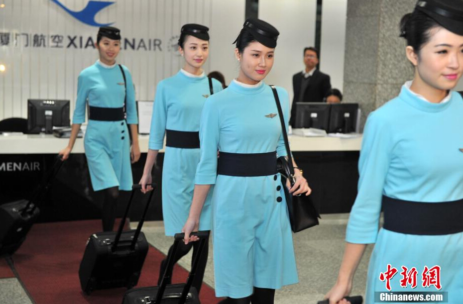 Airline stewardesses of Xiamen Air show their new uniforms on Feb. 6, 2015. 