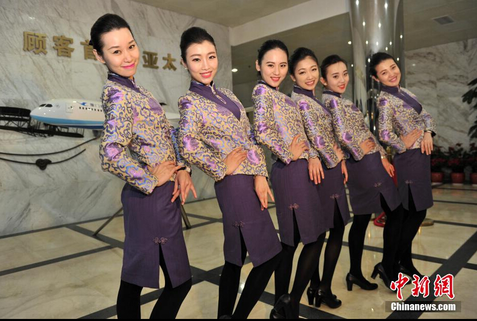 Airline stewardesses of Xiamen Air show their new uniforms on Feb. 6, 2015.