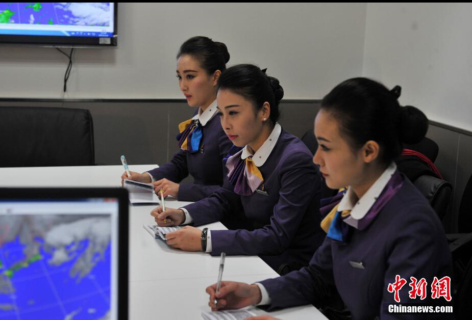 Airline stewardesses of Xiamen Air show their new uniforms on Feb. 6, 2015. 