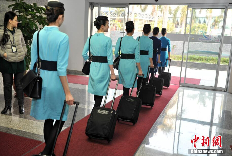 Airline stewardesses of Xiamen Air show their new uniforms on Feb. 6, 2015.