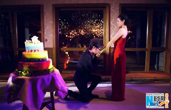 Veteran Chinese rocker Wang Feng goes down on one knee to propose to actress Zhang Ziyi at her birthday party on Saturday. Zhang, star of the 2000 movie Crouching Tiger, Hidden Dragon, said: 'Yes, I do', amid tears in front of relatives and friends, including singers Na Ying and Leehom Wang. [Photo/Xinhuanet.com]