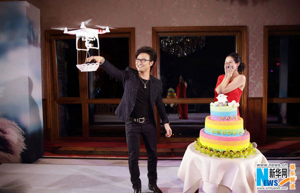 Wang takes an engagement ring from a basket, delivered by drone. [Photo/Xinhuanet.com]