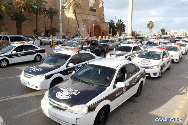 Police cars are parked on Martyrs Square before the parade in Tripoli, Libya on Feb. 9, 2015. Police and army forces for Libya's Tripoli authority on Monday performed a parade on main streets in Libya's capital city to show their confidence in safeguarding the city. [Photo/Xinhua]