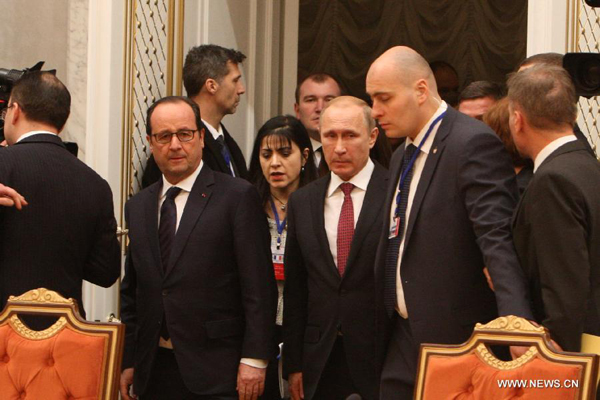 French President Francois Hollande (1st L, front) and Russian President Vladimir Putin (C, front) arrive for the four-way peace talks on the Ukraine crisis in Minsk, Belarus, on Feb. 11, 2015. Four-way peace talks on the Ukraine crisis resumed Wednesday in the Belarusian capital as heads of state and government of Russia, France, Germany and Ukraine were joined by their respective entourages.