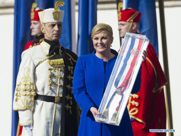 Kolinda Grabar-Kitarovic poses with the presidential sash after taking the oath of office as the President of Croatia during an official inauguration ceremony in Zagreb, capital of Croatia, Feb. 15, 2015. Kolinda Grabar-Kitarovic was sworn in as Croatia's President here on Sunday. She is the fourth President of Croatia and also the first woman to hold the title of Croatian President since the country's independence in 1991. [Photo/Xinhua]