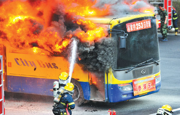 Firefighters combat a fire on a bus during a drill in Chongqing, Southwest China. Liu Chan / Xinhua