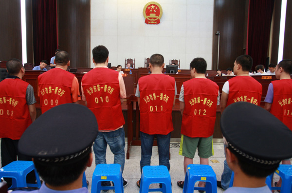 Suspects clad in detainee uniforms appear at a trial in Intermediate People's Court of Changsha, Hunan province, in July. Zhou Qiang / for China Daily
