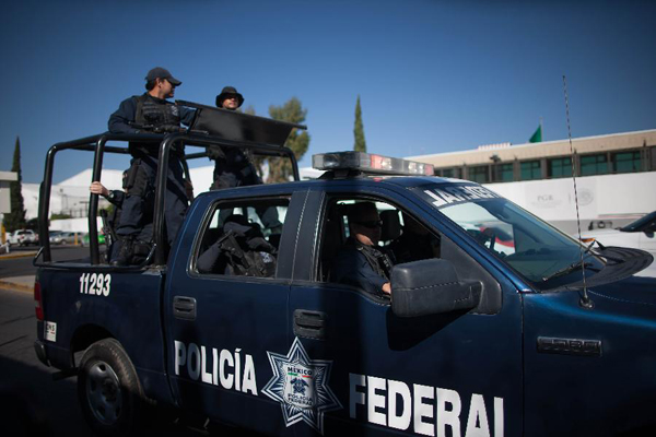 Federal Police members patrol outside the Mexico's Attorney General's Office in Mexico City, Mexico, on Feb. 27, 2015. Servando Gomez, alias 'La Tuta', the country's most wanted drug lord, was arrested early Friday in Morelia by members of the Federal Police during an operation, according to local press. 