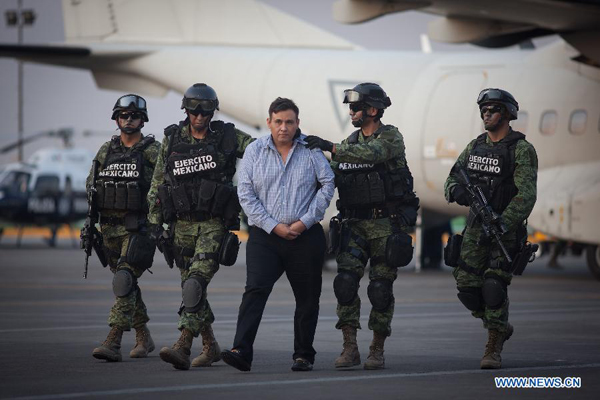 Mexican Army personnel escort Omar Trevino Morales (C) in Mexico City, capital of Mexico, on March 4, 2015. Mexican authorities on Wednesday arrested the head of the country's northern Los Zetas drug cartel, Omar Trevino Morales.