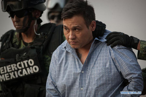 Mexican Army personnel escort Omar Trevino Morales (R) in Mexico City, capital of Mexico, on March 4, 2015. Mexican authorities on Wednesday arrested the head of the country's northern Los Zetas drug cartel, Omar Trevino Morales. [Photo/Xinhua]