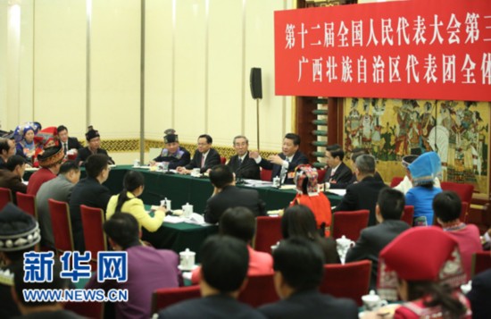 President Xi Jinping talks to deputies from Guangxi Zhuang Autonomous Region on Sunday. [Photo/Xinhua]