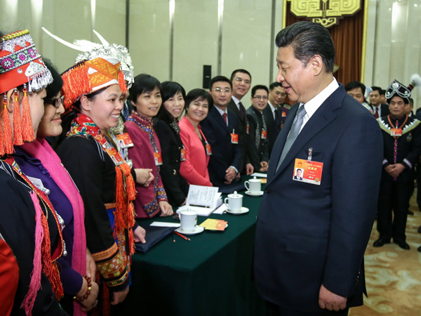 President Xi Jinping talks to female deputies from Guangxi on Sunday, sending International Women's Day greetings to them as well as all women across the country. Lan Hongguang / Xinhua 