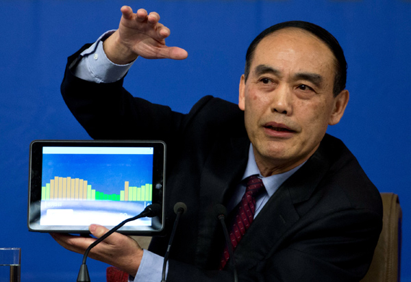 Yuan Si, vicechairman of the Environmental Protection and Resources Conservation Committee of the National People’s Congress, shows an information graphic to reporters during an NPC news conference in Beijing on Tuesday. [Photo/China Daily]