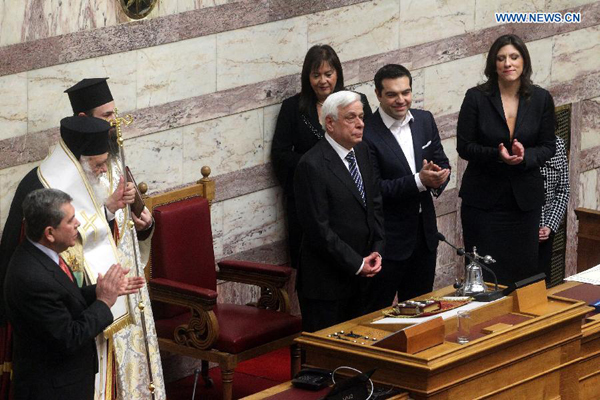 Newly elected Greek President Prokopis Pavlopoulos(C) takes part in a swearing-in ceremony inside the parliament in Athens, Greek, on March 13, 2015. The new president of the Hellenic Republic, Prokopis Pavlopoulos, was sworn in on Friday. 