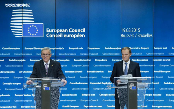 European Council President Donald Tusk (R) and European Commission President Jean-Claude Juncker attend a press conference after the first day of the EU's spring summit in Brussels, Belgium, on March 19, 2015. The European Union (EU)'s sanctions policy against Russia over the Ukraine crisis would be linked to the implementation of the Minsk agreement till the end of 2015, European leaders agreed on Thursday. 
