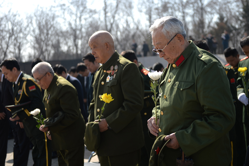 Remains of 68 Chinese soldiers killed in the 1950-53 Korean War were reburied in northeast China after they were excavated and returned from the Republic of Korea (ROK). A grand ceremony was held March 21, 2015 at Martyrs&apos; Park in Shenyang, capital city of Liaoning Province. It was attended by veterans, relatives of the soldiers and representatives from all walks of life. [Photo/Xinhua] 