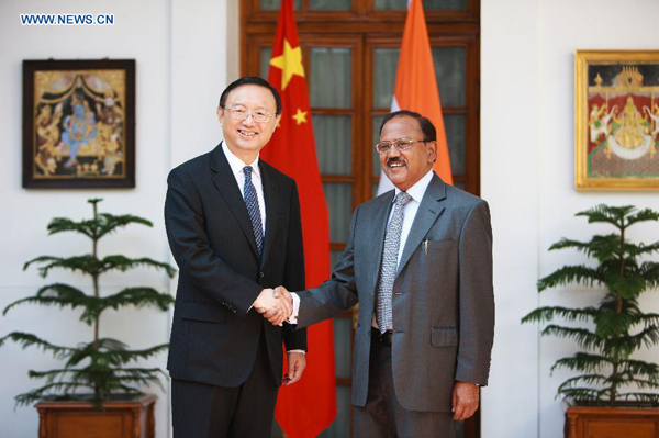 Chinese State Councilor Yang Jiechi (L), who is also Chinese Special Representative on China-India Boundary Question, shakes hands with Indian National Security Advisor Ajit Doval at Hyderabad House in New Delhi, India, March 23, 2015. The 18th round of talks on China-India Boundary Question was held here on Monday.