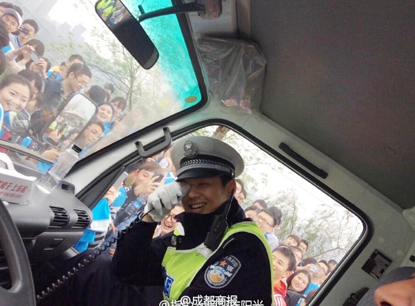 Runners surround a police van in which the handsome policeman sits, March 22, 2015. [Photo/Sina Weibo]