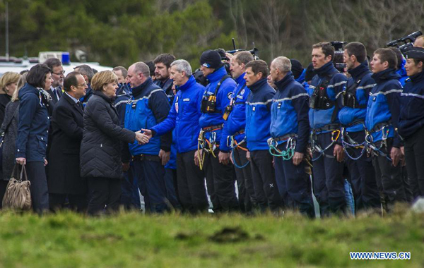 French President Francois Hollande(2nd R, front) and German Chancellor Angela Merkel(1st R, front) shake hands with rescue team members in Seyne-les-Alpes, France, on March 25, 2015. French President Francois Hollande, German Chancellor Angela Merkel and Spanish Prime Minister Mariano Rajoy arrived Wednesday afternoon in Seyne-Les-Alpes, the site of an operation center for Germanwings' crashed A320 in southern France. 