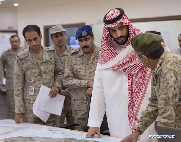 Saudi Arabian Defense Minister Mohammed Bin Salman (2nd R) listens to briefing by military officers on the operation at the military operation center in the country's southern area bordering Yemen, March 25, 2015. Adel al-Jubeir, the Saudi ambassador to Washington, announced late Wednesday that his country and its Gulf allies have launched airstrikes on the Houthi rebels in Yemen to protect the legitimate government of President Abd-Rabbu Mansour Hadi.