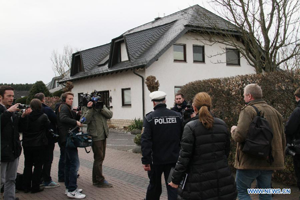 Investigators go to enter Andreas Lubitz's home, the co-pilot who was charged of deliberately crashing Germanwings A320 flight, in Montabaur, western Germany, on March 26, 2015. German police are keeping the Germanwings' co-pilot's home in the town of Montabaur, about 100 km northwest of Frankfurt, under surveillance. 